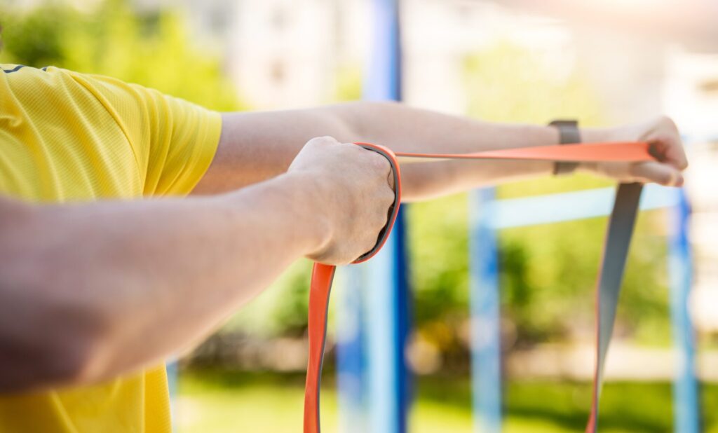 Man exercising with resistance rubber band